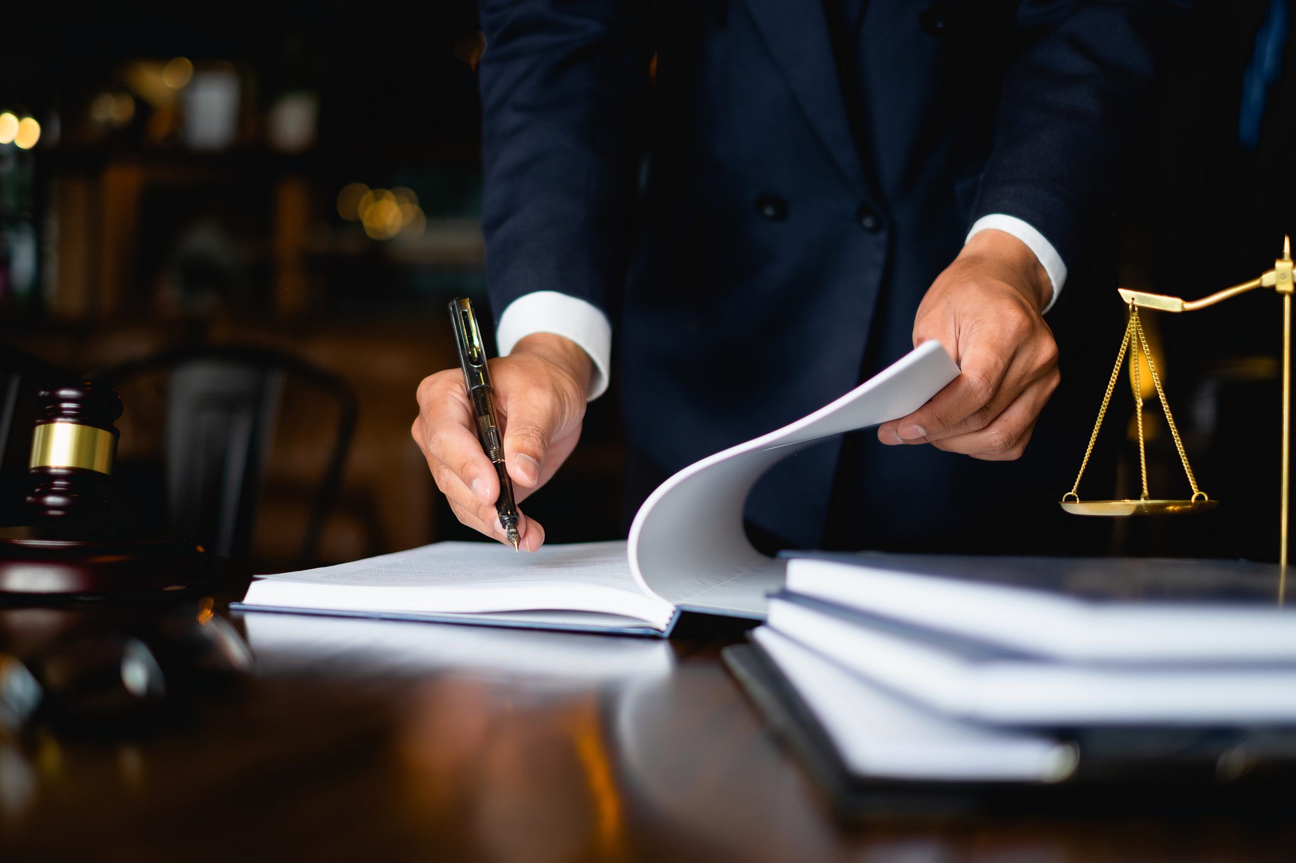 Close up lawyer working or reading lawbook in office workplace